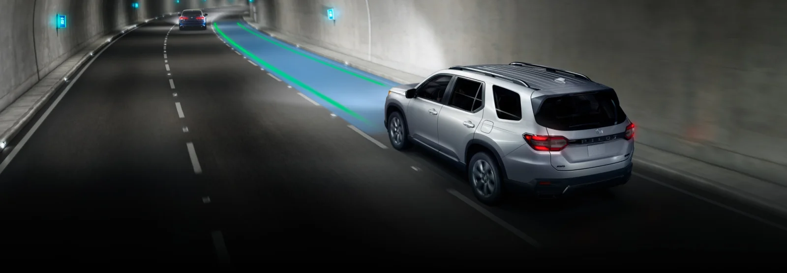 A silver Pilot in a tunnel with a lane-keeping graphic highlighting its lane.