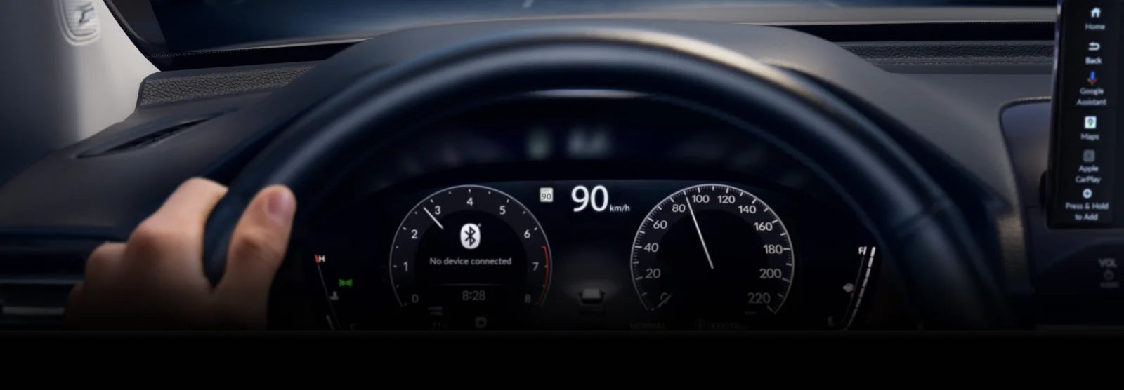 The Pilot digital driver display seen through the steering wheel.